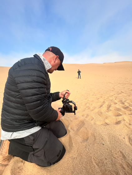 Presenter Matthew Grimshaw being filmed in the Namibian desert.
